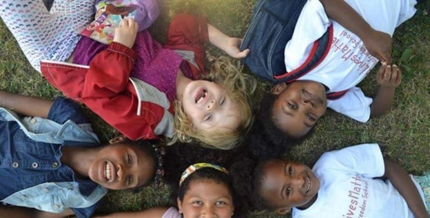 children laying on the ground laughing