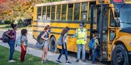 kids getting on yellow school bus