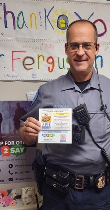 A police officer holding a placard