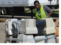 Volunteer handling electronic waste at a NoHaz collection event