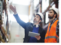 Photo of two men working at a manufacturing facility