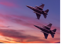 Military jets flying in a sunset sky