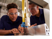 Young professional being trained at a manufacturing facility
