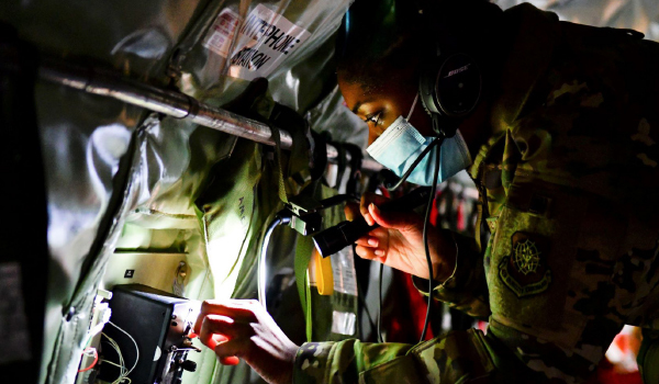 Servicewoman inspecting machinery