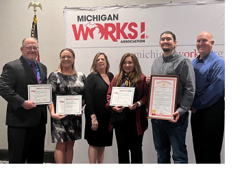 Oakland County MiWorks! Staff and Barron Industries Staff holding their Impact Award Plaques