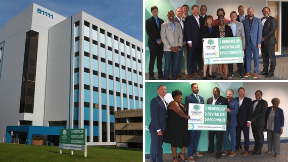 Pontiac City Council, Oakland County Board of Commissioners and County Executive Dave Coulter pose with Pontiac redevelopment signs.