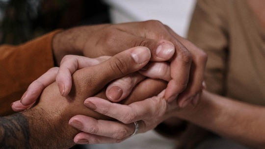 Hands holding each other.