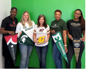 Career and Education Navigators posing with school flags