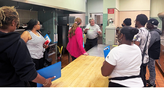 Cooks listening to a presentation at the Make it to Scale Prep Kitchen in Pontiac