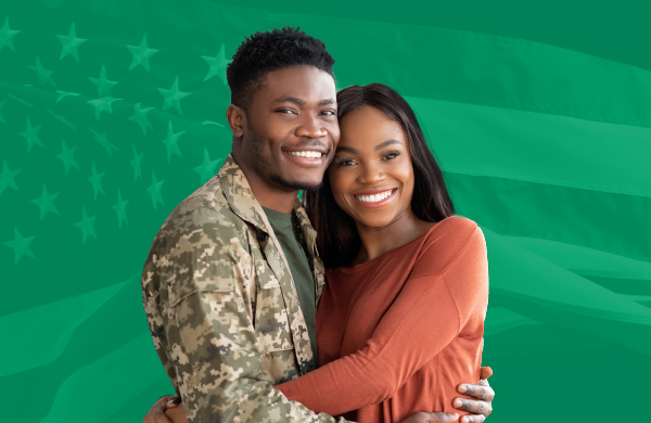 Photo of a smiling veteran hugging his wife.