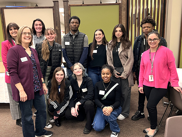 Commissioner Erickson Gault stands with a large group of high school students during lunch on Youth in Government Day on February 9, 2024