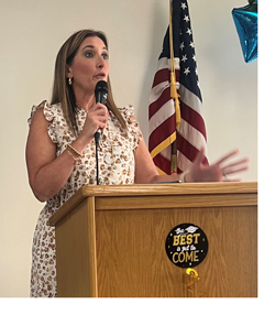 Jennifer Llewellyn speaking at a podium