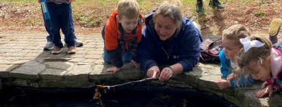 naturalist, children studying at a pond