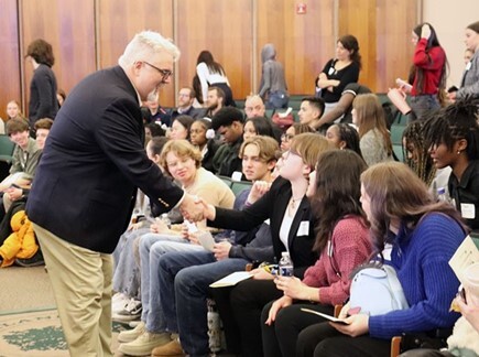 Commissioner Smiley shakes hands with high school students during Youth in Government Day on Feb. 7, 2025