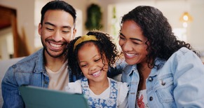 Smiling family talking on a tablet