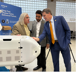 Dom Holmes and Sean Carlson looking at an Amazon Prime Drone