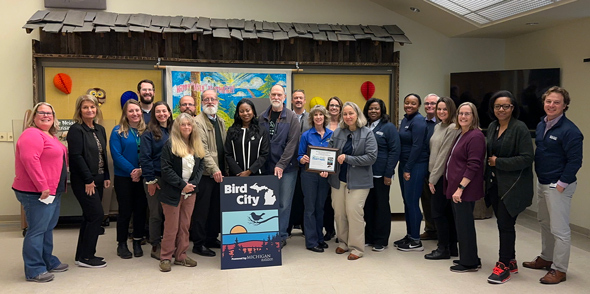 Michigan Audubon presents Oakland County with the Bird City Michigan recognition certificate.