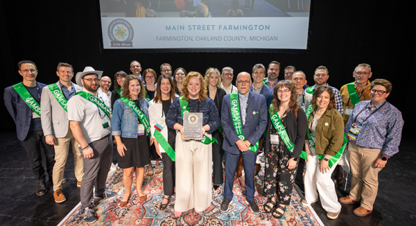 Main Street Oakland County and Farmington leaders gather to receive the Great American Main Street Award