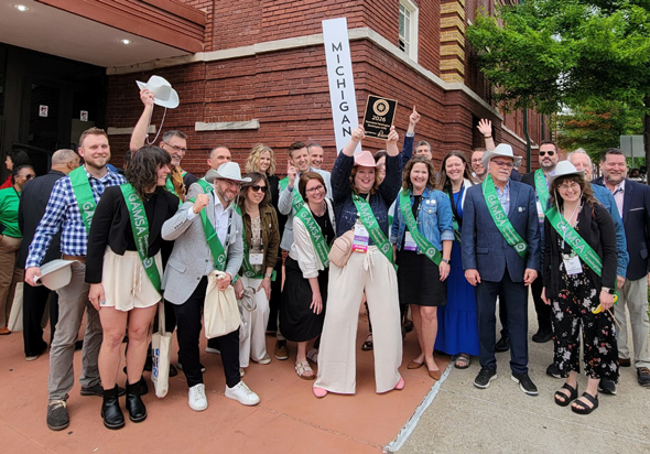 Farmington, Oakland County, and Michigan leaders gathered at the Main Street Now Conference with their Great American Main Street Award.