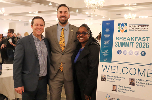 Three community stakeholders and leaders posing for a photo at the 2026 Main Street Summit.