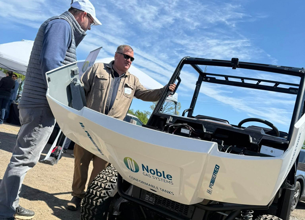 Holly ORV Park Industry Day attendees looking under the hood of a Noble Gas Systems vehicle.