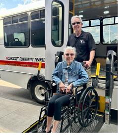 Transit rider in a wheelchair being assisted by a bus driver.