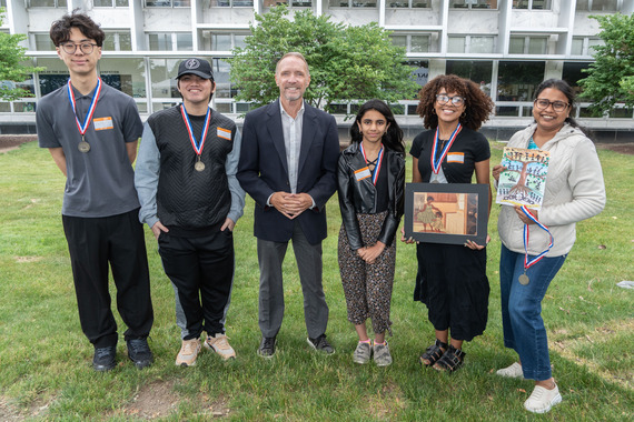 Executive David Coulter stands with Juneteenth Art & Essay Winners 2026.
