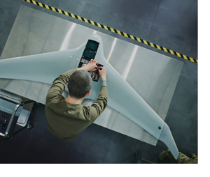 A technician working on a military drone.