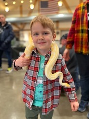 Kid with snake around his neck