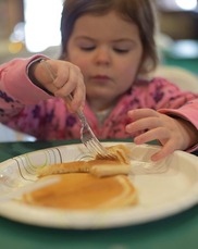 Kid eating a pancake