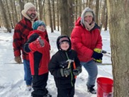 family making maple syrup