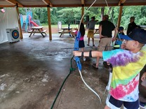 child shooting an arrow at a target
