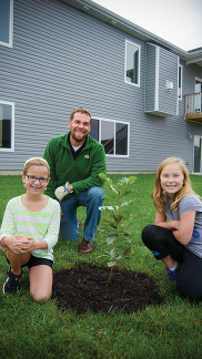 father and daughter with tree