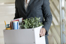 Office worker carrying box of desk items