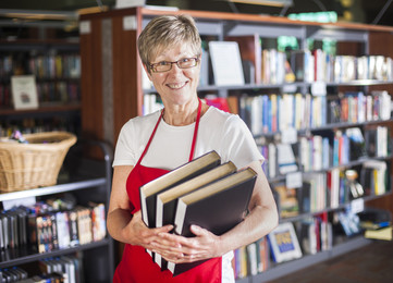 Woman librarian holding books