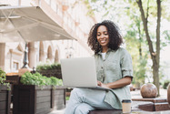 woman viewing laptop outside