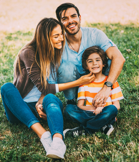 Family of three on lawn