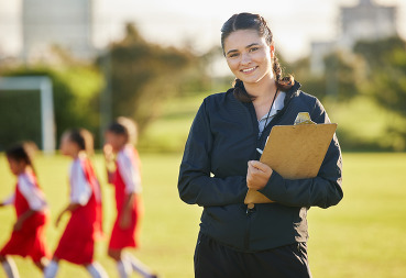 Young woman coaching children outside