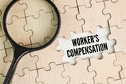 Puzzle with a magnifying glass highlighting the words "workers compensation"