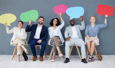 Five people sitting holding blank cutouts of word clouds near their heads.