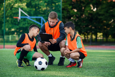 Three soccer players on the field
