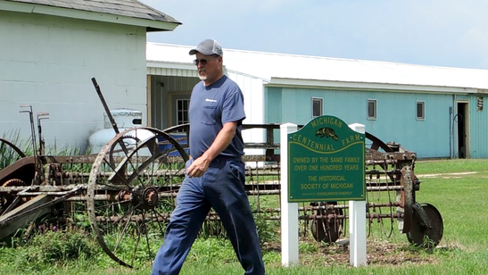 Hehlden Farms owner and operator Matt Hehl walks past the 'Centennial Farm' sign on his 35-acre property in Polkton Township.