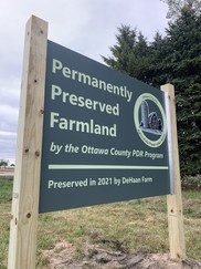 The new Ottawa County Permanently Preserved Farmland sign on the DeHaan farm property. 