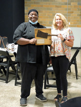 Julie Lamer and The Farmhouse of Zeeland chef pose with the Harvest Knife award. 