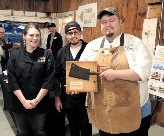 Sand Point Beach House chef team poses with Harvest Knife trophy after winning chefs' competition.