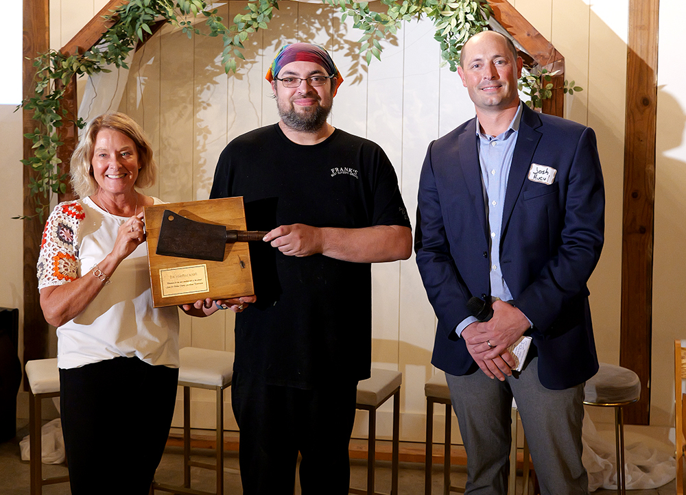 Farmland Preservation Analyst Julie Lamer poses with chefs' competition winner Brad Post and Agricultural Preservation Board Chair Josh Hucul