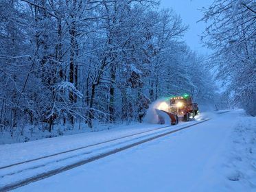 OCRC snow plow operating on a road at night