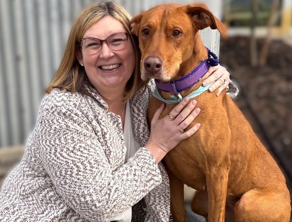 Treasurer Cheryl Clark and posed with an orange dog