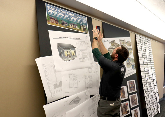 A member of the public grabs the QR code for the new Small-Footprint Home website following the official website launch. 