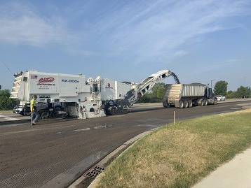 Asphalt milling machine operating in a road construction zone